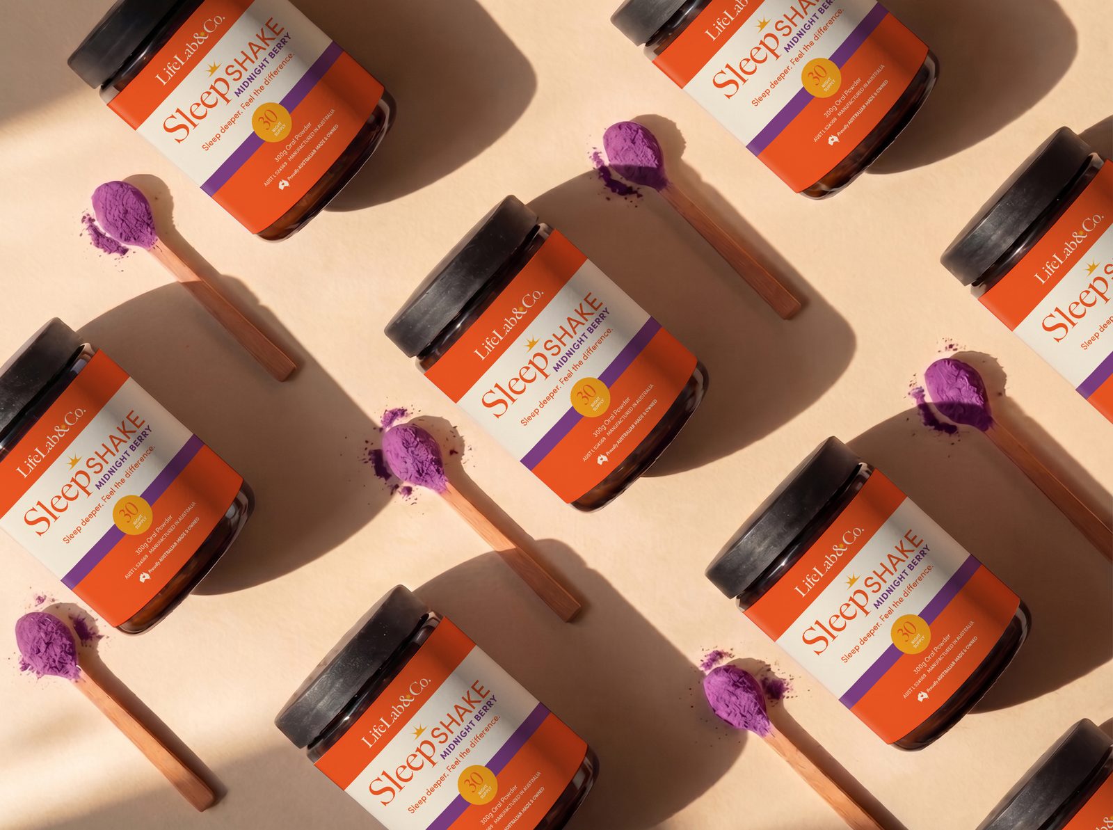 SleepShake jars and spoons of berry powder, flat lay